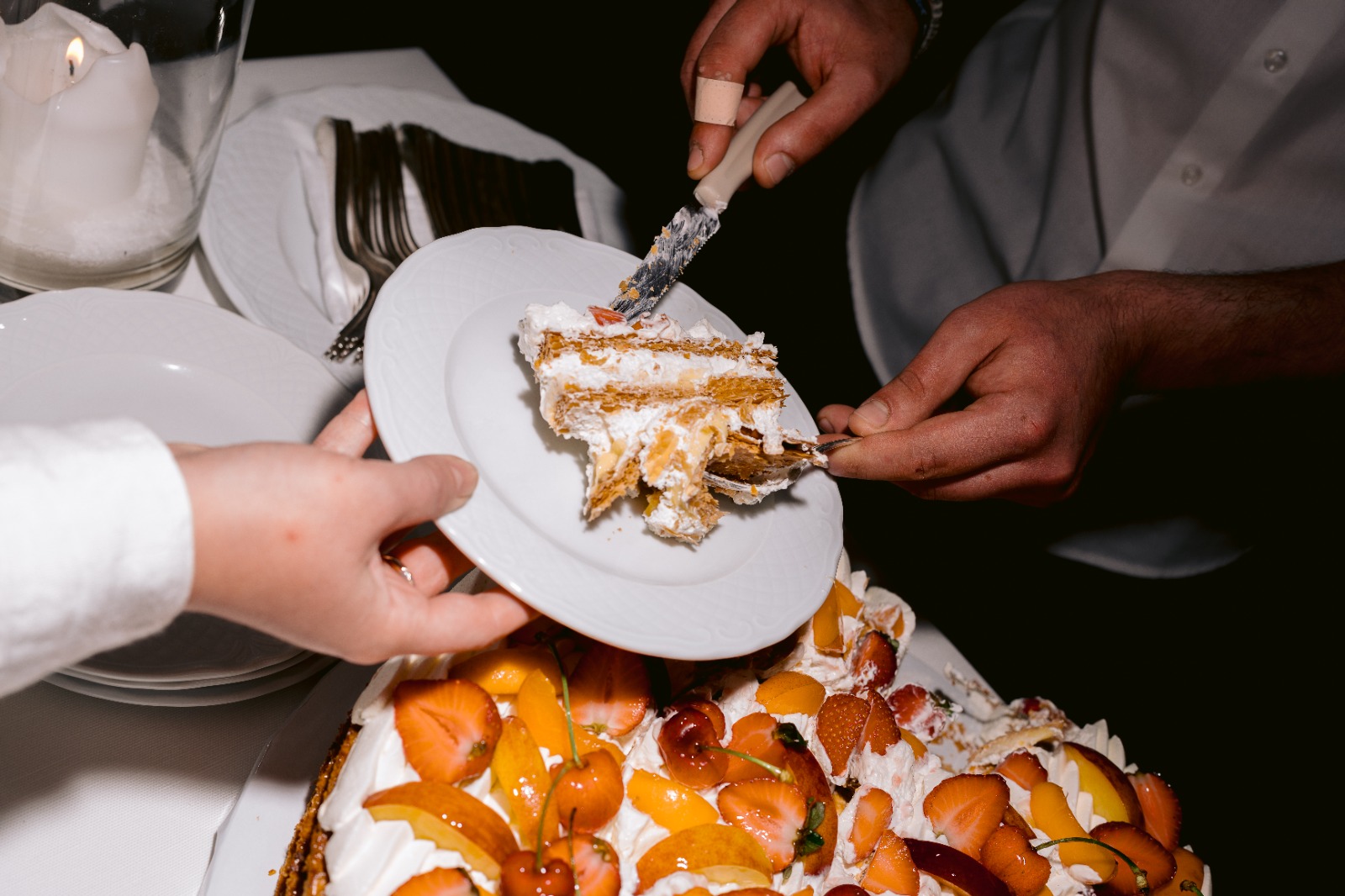 Cutting the millefeuille wedding cake